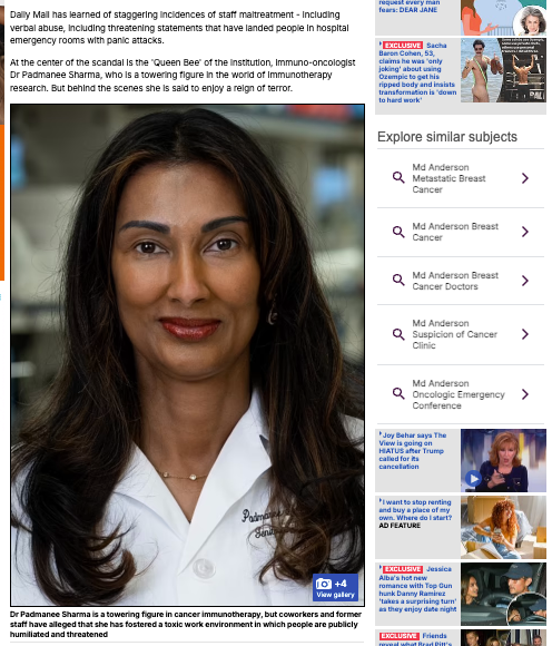 A person with long hair wearing a white coat